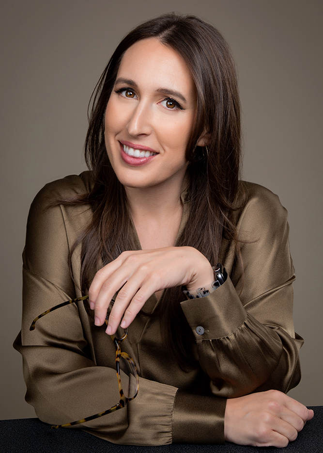 Andrea Morgan holding glasses smiling